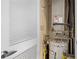 Water heater and HVAC system located in utility closet with white louvered door at 400 W Peachtree Nw St # 3114, Atlanta, GA 30308
