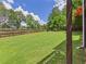 Large backyard with lush green grass and a wooden fence at 122 White Spruce Ct, Dallas, GA 30157