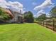 Expansive backyard with mature trees and wooden fence at 122 White Spruce Ct, Dallas, GA 30157