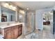 Bright bathroom features a tiled shower, vanity with a bowl sink, and a large mirror reflecting the closet at 122 White Spruce Ct, Dallas, GA 30157