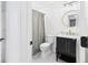 Bathroom featuring a shower/tub combo, white toilet, dark vanity, and round mirror at 122 White Spruce Ct, Dallas, GA 30157