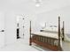 Bright bedroom with a four-poster bed, ensuite bathroom, and a neutral color palette for relaxation at 122 White Spruce Ct, Dallas, GA 30157
