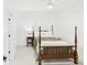 This bedroom features a four-poster bed, neutral carpet, and a ceiling fan at 122 White Spruce Ct, Dallas, GA 30157