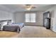 Bright bedroom with neutral carpet, ceiling fan, and television on a dresser for comfort at 122 White Spruce Ct, Dallas, GA 30157