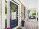 Inviting front door with stone accents and a cozy seating area on the porch at 122 White Spruce Ct, Dallas, GA 30157