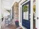 Charming front door with a wreath, rocking chairs, and stone detailing around the porch at 122 White Spruce Ct, Dallas, GA 30157