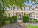 Inviting front porch with stone accents, an American flag, and a cozy seating area at 122 White Spruce Ct, Dallas, GA 30157