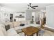 Comfortable living room with a ceiling fan, plush couch, and a glimpse into the modern kitchen at 122 White Spruce Ct, Dallas, GA 30157
