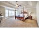 Spacious main bedroom with a tray ceiling, a four-poster bed, and large windows offering natural light at 122 White Spruce Ct, Dallas, GA 30157