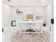 Bright home office with white built-in bookcases, cabinets, and a stylish rug under the desk at 122 White Spruce Ct, Dallas, GA 30157