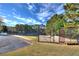 Fenced tennis courts with walkway at 122 White Spruce Ct, Dallas, GA 30157