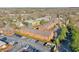 Aerial view showcasing brick building and ample parking lot surrounded by mature trees at 235 Founders Mill Ct, Roswell, GA 30075