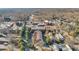 Aerial view of townhome building surrounded by trees and businesses with parking at 235 Founders Mill Ct, Roswell, GA 30075