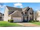 Charming two-story brick home with a well-manicured lawn and two car garage at 2468 Cannon Farm Ln, Duluth, GA 30097