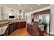 Spacious kitchen featuring stainless refrigerator, granite countertops, wooden floors and ample cabinet storage at 2468 Cannon Farm Ln, Duluth, GA 30097