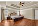 Spacious main bedroom with hardwood floors, tray ceiling, and natural light at 2468 Cannon Farm Ln, Duluth, GA 30097