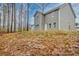 Backyard with view of home's exterior features a large grassy area and mature trees at 370 Cassidy Trl, Douglasville, GA 30134