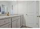 Bathroom featuring gray cabinets with white granite, updated finishes and a doorway at 370 Cassidy Trl, Douglasville, GA 30134