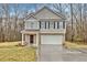 Charming two-story home with a brick front, black shutters, and a well-manicured lawn at 370 Cassidy Trl, Douglasville, GA 30134