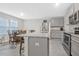 Bright kitchen and dining area with stainless steel appliances and gray cabinets at 370 Cassidy Trl, Douglasville, GA 30134