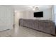 Spacious living room featuring a large gray couch, ceiling fan, and wood-look laminate flooring at 370 Cassidy Trl, Douglasville, GA 30134