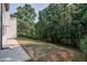 Spacious backyard with a view of the mature trees behind the property at 515 Allens Landing Ct, Lawrenceville, GA 30045