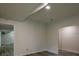 Finished basement space with an open floor plan, gray wood floors, neutral paint, and doorways at 515 Allens Landing Ct, Lawrenceville, GA 30045