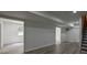 Spacious finished basement with sleek gray flooring and ample lighting at 515 Allens Landing Ct, Lawrenceville, GA 30045