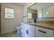 Bathroom with large mirror, white vanity and stone countertops at 515 Allens Landing Ct, Lawrenceville, GA 30045