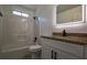 Modern bathroom featuring a shower-tub combo, illuminated mirror, and vanity with granite countertop at 515 Allens Landing Ct, Lawrenceville, GA 30045