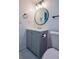 Bathroom featuring a grey vanity with a round mirror, modern lights, and an updated toilet at 515 Allens Landing Ct, Lawrenceville, GA 30045