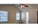 Bright bedroom with vaulted ceiling, two windows, and ceiling fan at 515 Allens Landing Ct, Lawrenceville, GA 30045