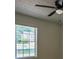 Bright bedroom featuring a ceiling fan and a large window offering ample natural light at 515 Allens Landing Ct, Lawrenceville, GA 30045