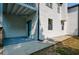 Exterior of the home featuring a blue entry door, wood siding, and a concrete patio at 515 Allens Landing Ct, Lawrenceville, GA 30045