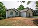 View of the home's exterior, highlighting the two-car garage, front door, and yard at 515 Allens Landing Ct, Lawrenceville, GA 30045