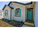 Close-up of the front entrance with a turquoise door and turquoise shutters at 515 Allens Landing Ct, Lawrenceville, GA 30045