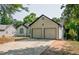 View of the home's exterior, highlighting the two-car garage and driveway at 515 Allens Landing Ct, Lawrenceville, GA 30045