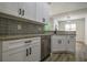 A kitchen with white cabinets, granite countertops, and stainless steel dishwasher at 515 Allens Landing Ct, Lawrenceville, GA 30045