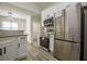 Modern kitchen features stainless steel appliances, white cabinets, and granite countertops at 515 Allens Landing Ct, Lawrenceville, GA 30045
