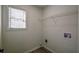 Functional laundry room with overhead shelving, a window, and washer/dryer hookups at 515 Allens Landing Ct, Lawrenceville, GA 30045