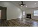 Bright living room features a fireplace, ceiling fan, and wood-look flooring at 515 Allens Landing Ct, Lawrenceville, GA 30045