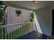 View of a porch with white railings, overlooking green scenery, and a potted plant at 515 Allens Landing Ct, Lawrenceville, GA 30045