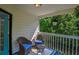 Cozy porch features wicker chairs with blue cushions and views of lush greenery at 515 Allens Landing Ct, Lawrenceville, GA 30045