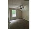 Neutral bedroom features a ceiling fan and a sunlit window at 7250 Bridgeport Ct, Austell, GA 30168