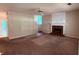 Open living room featuring a fireplace and a ceiling fan at 7250 Bridgeport Ct, Austell, GA 30168
