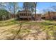 View of backyard, the house exterior, including the sunroom and a lush, well-maintained lawn at 3937 Locklear Way, Atlanta, GA 30360