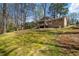 Spacious backyard with mature trees, lawn, offering ample space for outdoor activities and landscaping opportunities at 3937 Locklear Way, Atlanta, GA 30360