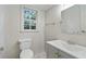 Well lit half bathroom featuring geometric tile flooring, a modern vanity, and a bright, airy window at 3937 Locklear Way, Atlanta, GA 30360