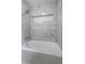 Elegant bathroom featuring a modern tub with marble tile surround and shower head at 3937 Locklear Way, Atlanta, GA 30360