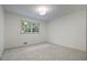 Cozy bedroom with plush carpet, ample natural light from large window, and modern lighting at 3937 Locklear Way, Atlanta, GA 30360